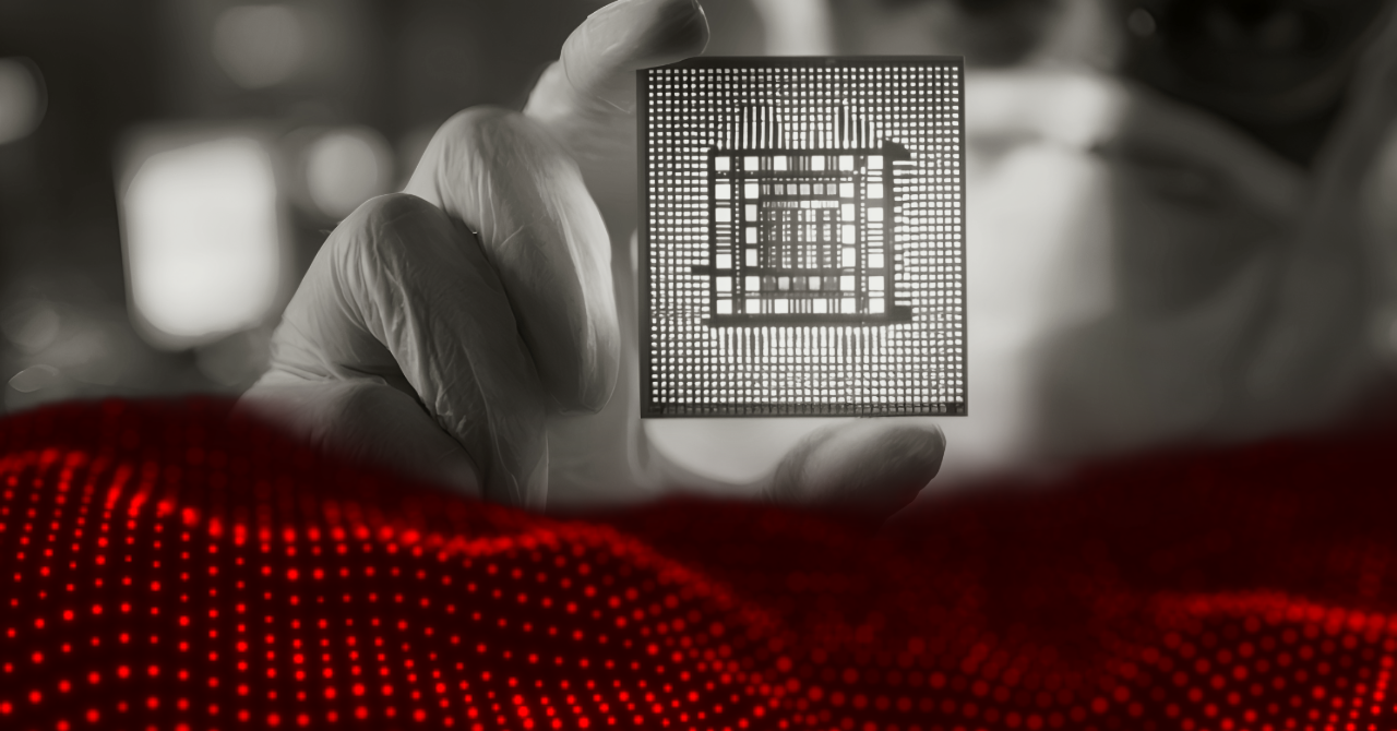 gloved hand holding a microchip