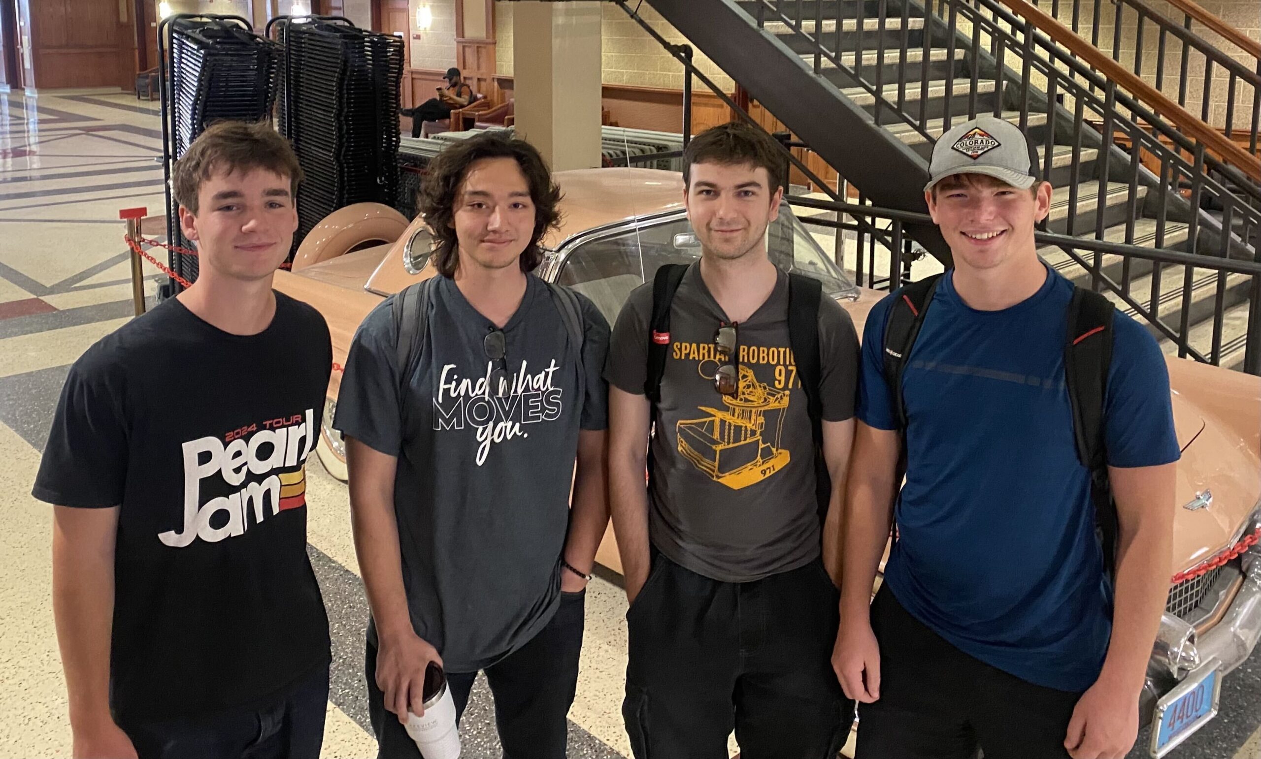 Four members of the FORGE-SDL undergraduate team standing together indoors.